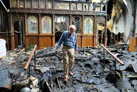 Tom Evangelou, the treasurer of St. John the Baptist Albanian Orthodox Church in South Boston spent the day trying to recover church items that were damaged in a five-alarm fire on Tuesday.
